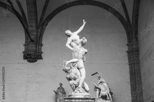 Sculpture The Rape of Sabine Women, made by sculptor Giambologna. Loggia dei Lanzi on the Piazza della Signoria in Florence, Italy. Black and white photo.