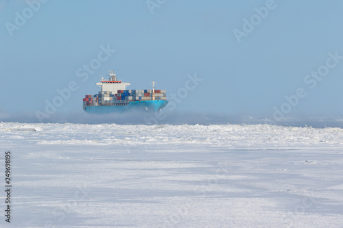 Container cargo ship on icy waters