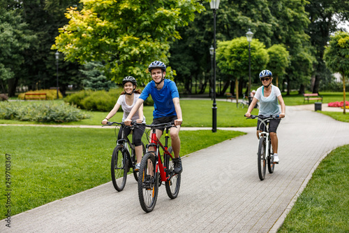 Healthy lifestyle - people riding bicycles in city park