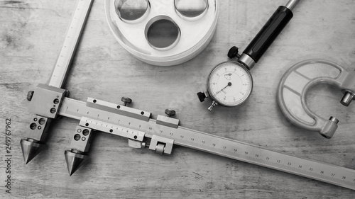 Metal measuring instruments on a wooden table. Product quality control.