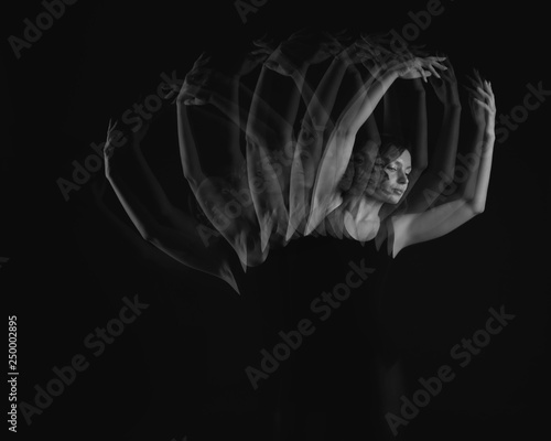 Stroboscopic photo of beautiful moving young woman on dark background