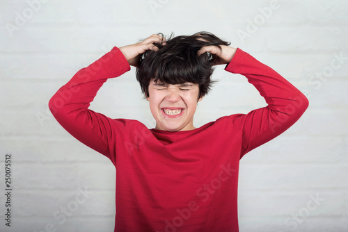 boy scratching his hair for head lice