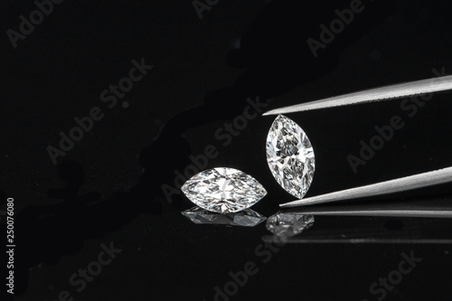 marquise diamond with tweezer on black background