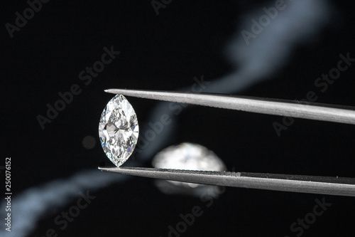 marquise diamond with tweezer on black background