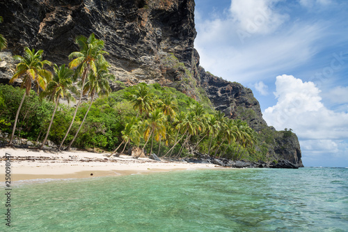 Tropical beach between the rocks. Paradise secluded island. 