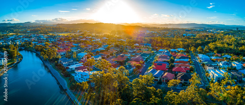 Sunset over luxury homes at Varsity Lakes suburb on the Gold Coast in Australia.