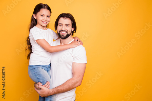 Portrait of her she his he nice adorable cute sweet lovely attractive cheerful people daddy holding in hands pre-teen girl spend time isolated on shine vivid pastel yellow background