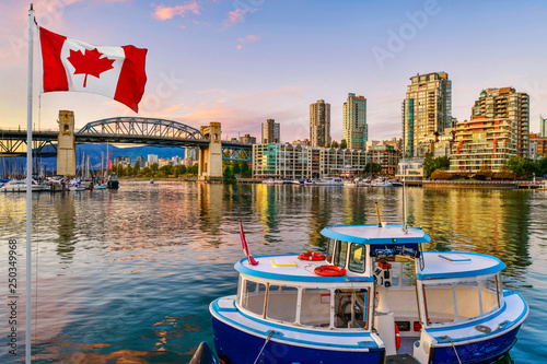 Ferry boat docked along in Granville island near Burrard Street Bridge at twilight in Vancouver,Canada