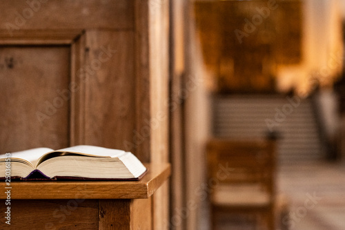 Holy book in front on a desk inside the church, closeup