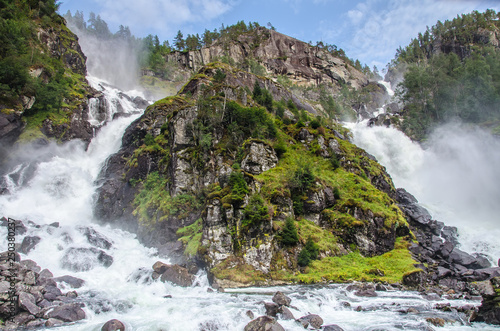 Close view of Latefossen waterfall in Hordaland, Norway, with blue sky above