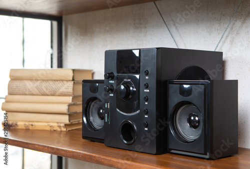 Compact music center in vintage residential loft interior on the shelf among books and accessories