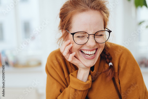 Pretty red-haired girl laughing portrait