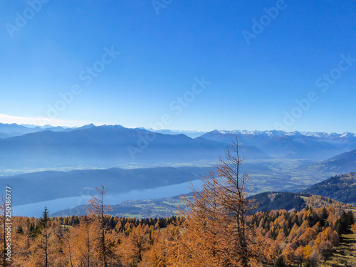 Millstäter Lake seen from Granattor, Austria. Beautiful autumn landscape. Lake stretches wide in the valley. Alps around it. Clear sky. Perfect weather and condition for a hike.