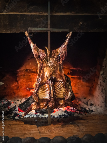 Lamb of Patagonia slowly roasted over the fire, typical dish of Chile and Argentina. Lamb to the post
