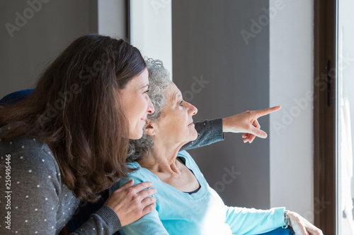 Adult daughter visiting elderly mother