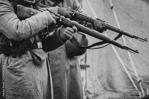 Two German soldiers of the Second World War with rifles in their hands ready to fire. Black and white photo