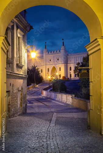 View of Lublin Castle through the arch at dusk in old town of Lublin, Poland