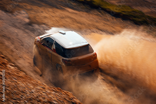 Rally vehicle going fast with mud and water splash. Car go fast at the rural road in Africa