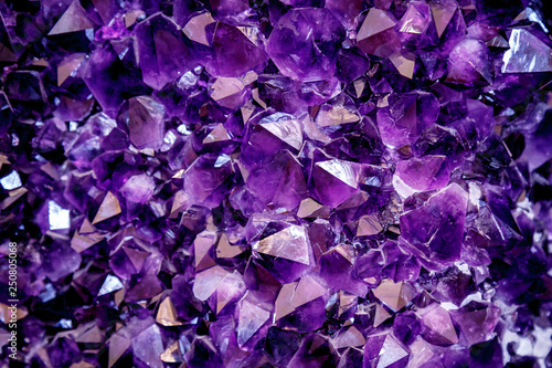 Amethyst purple crystal. Mineral crystals in the natural environment. Texture of precious and semiprecious gemstone.