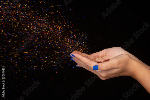 soffio sulla mano con brillantini colorati