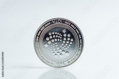 IOTA. Crypto currency silver coin, Macro shot of Iota coin isolated on white background, cut out Blockchain technology,