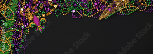 Purple, Gold, and Green Mardi Gras beads and decorations background