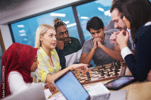 multiethnic group of business people playing chess