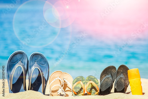 Stylish beautiful slippers in the sand on the sea background