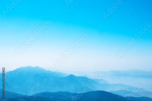 The mountains and forests with blue sky and white clouds at the peak of Inthanon national park (park name) in Chiang Mai province , Thailand in a foggy or misty day , real photo not graphic program. 