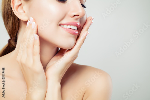 Healthy woman lips with glossy pink makeup and manicured hands with french manicure nails, face closeup