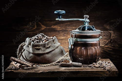 coffee mill and sack with beans on vintage wood