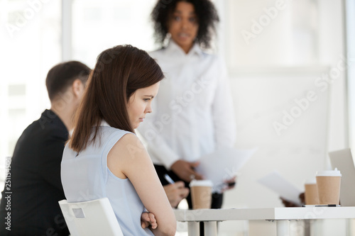 Young worker feels offended frustrated during meeting at work