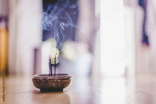 Smoking and smelling joss sticks at home, feng shui; Copy space