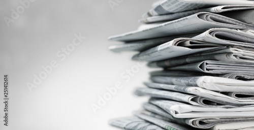 Pile of newspapers on white background