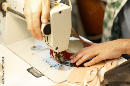 Close up of man hands as he operating an industrial sewing machine.