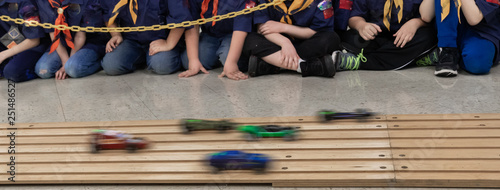 Boys watching wooden pinewood car race 