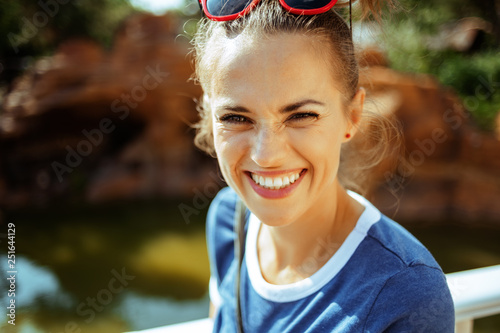 happy solo traveller woman having picturesque river cruise