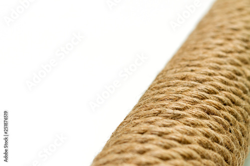 macro close-up sisal rope cat scratching post on white background, selective focus