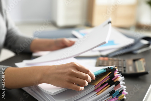 Office employee working with documents at table, closeup