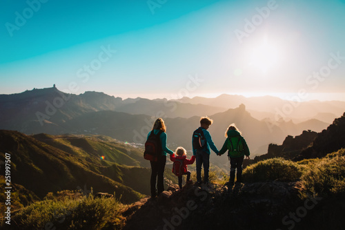 Mother with kids travel in mountains, family hiking