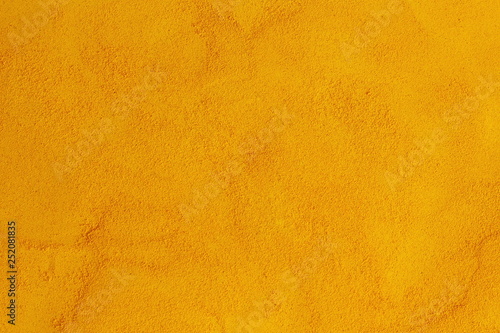 turmeric or curcumin longa powder isolated as herb or spice texture yellow food background