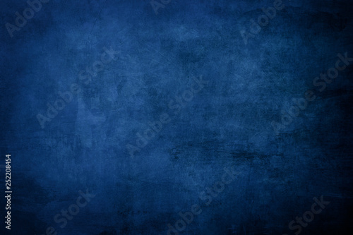 Dark blue grungy distressed canvas bacground