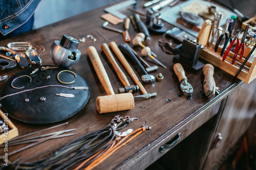 desk with a collection of jewelry tools for complete specific jewelry projects.