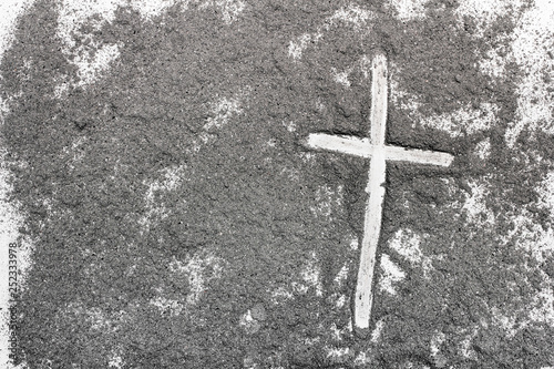 Cross and ash on white background - symbol of Ash Wednesday. Copy space