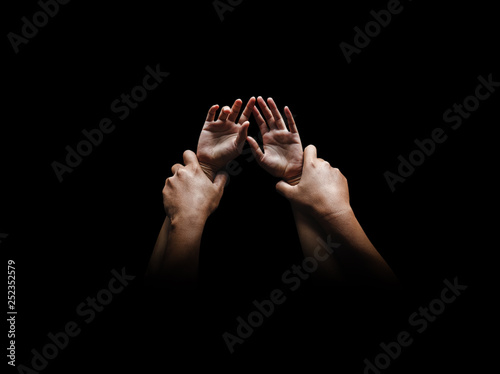 Man hands holding a woman hands for rape and sexual abuse concept isolated on black background