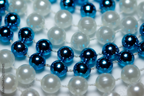 Circle abstract background of vibrant blue and white necklace beads