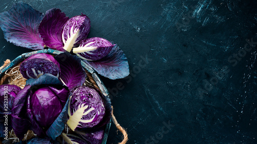Fresh cabbage. Purple cabbage on a black background. Organic food. Top view. Free space for your text.