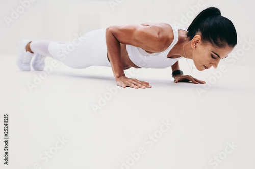 Athletic woman doing push ups