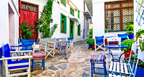 Traditional narrow streets with cute cafe bars in Greece. Skopelos island, Sporades