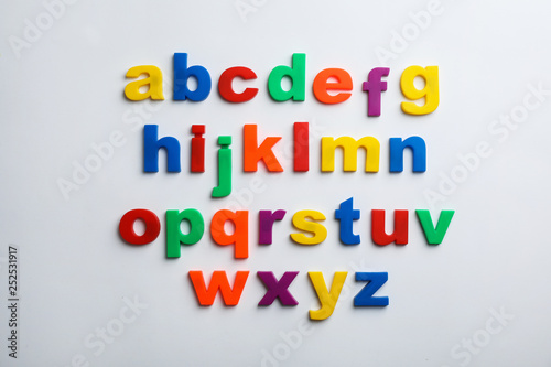 Plastic magnetic letters isolated on white, top view. Alphabetical order